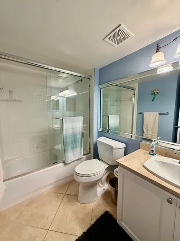 a bathroom with a toilet sink and shower