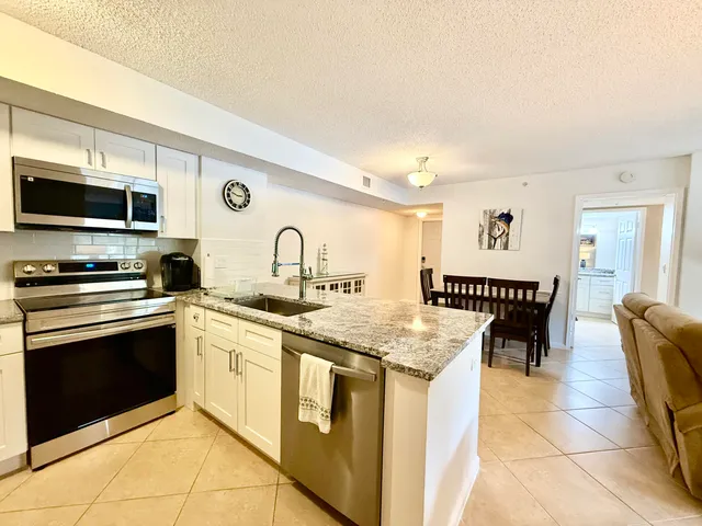 a kitchen with stainless steel appliances granite countertop a stove and a sink