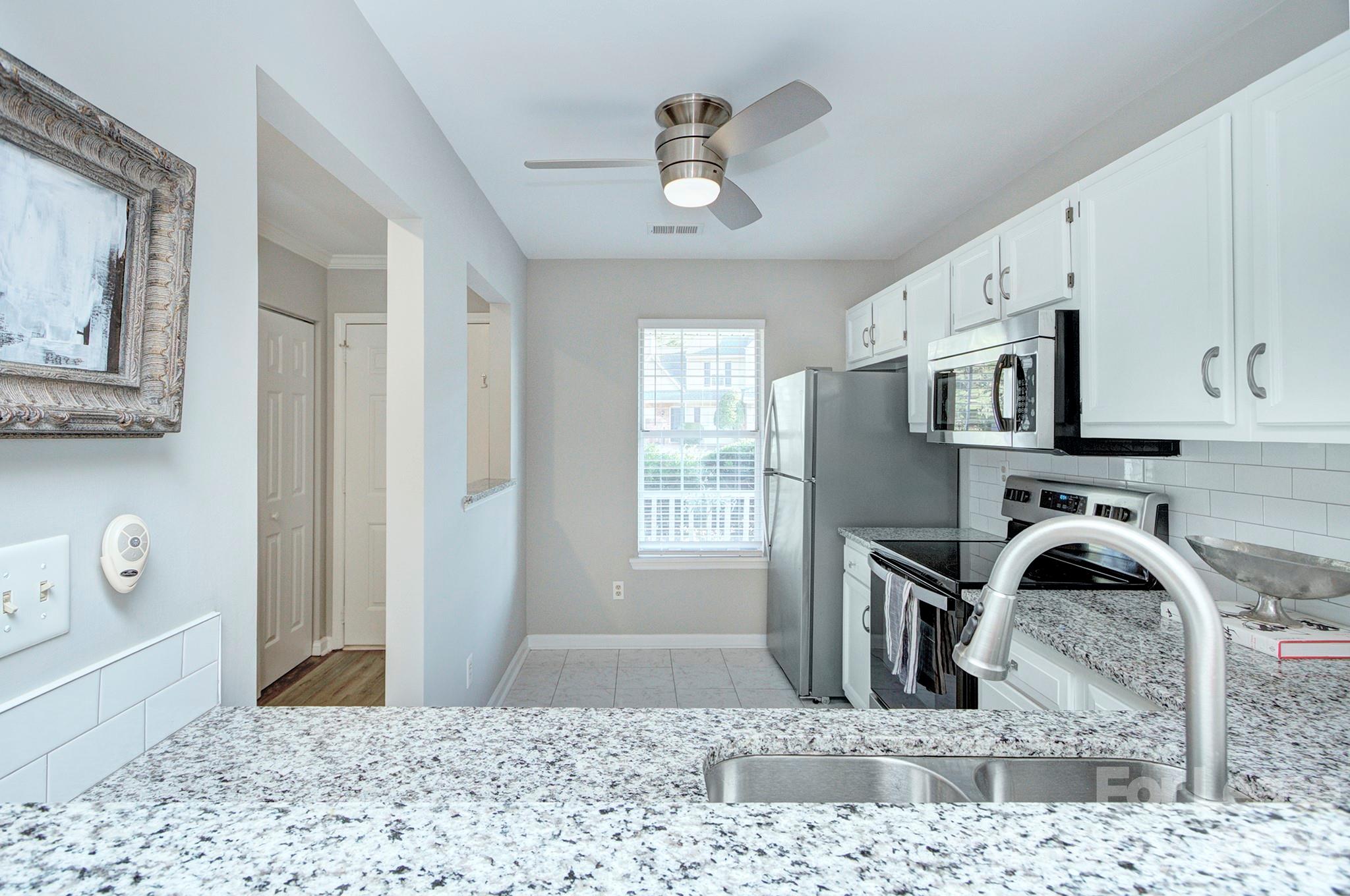 8268 Golf Ridge Drive Charlotte, NC 28277 - Photo 5 of 24 a view of a kitchen with wooden floor and windows