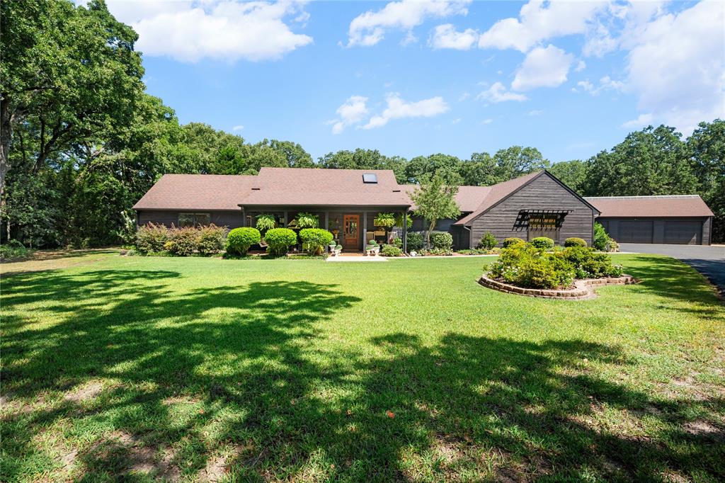 1516 Rancho Road Quinlan, TX 75474 - Photo 4 of 40 a front view of a house with garden