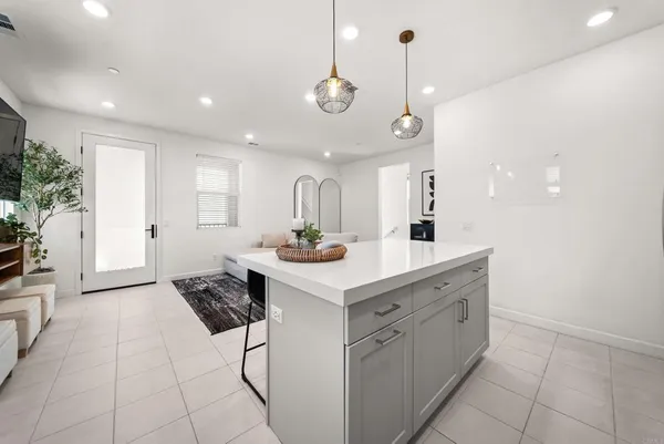a kitchen with a sink and chandelier