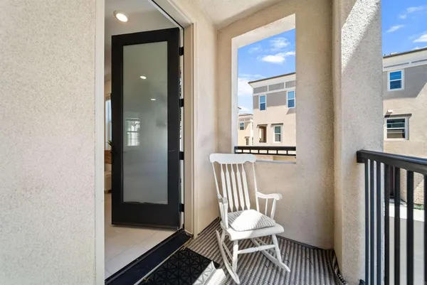 a view of a hallway with a livingroom and chair