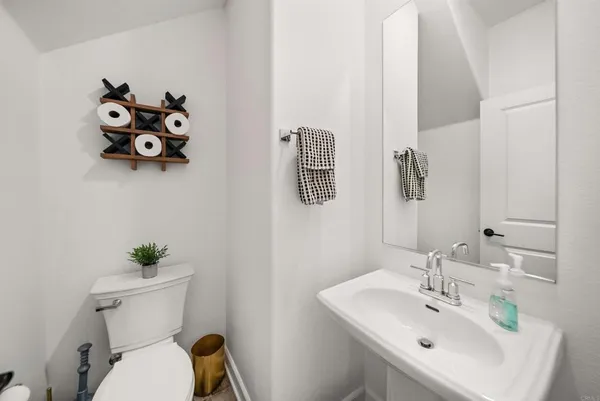 a bathroom with a sink mirror and toilet