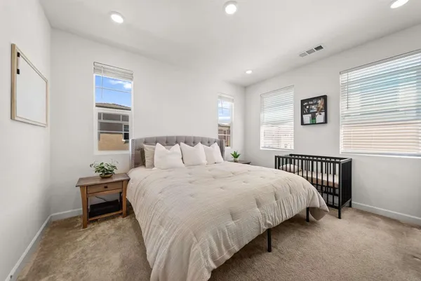 a bedroom with a bed and a window