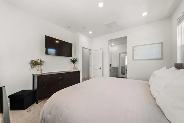 a bedroom with a bed and a flat screen tv
