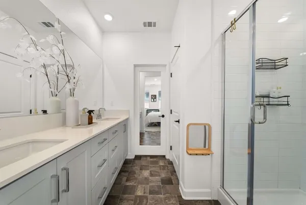 a spacious bathroom with a double vanity sink and a mirror