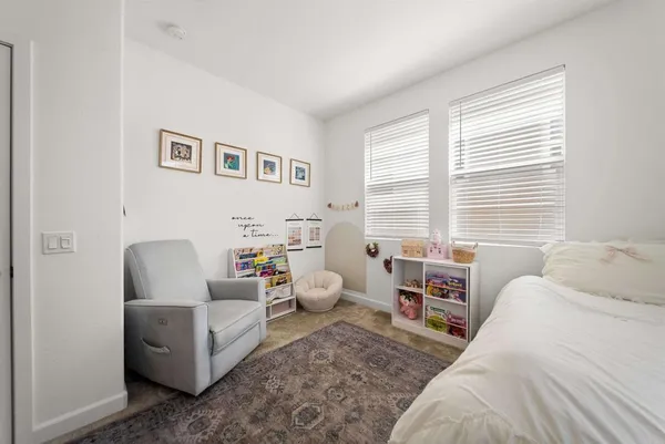 a bedroom with furniture and a window