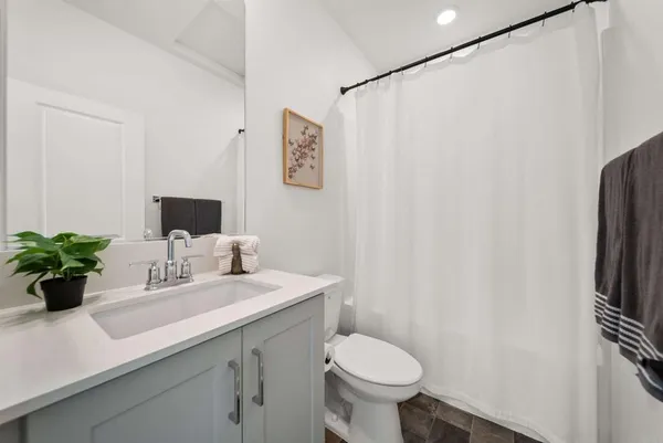 a bathroom with a sink toilet and mirror