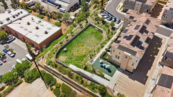 an aerial view of a residential apartment building with a yard