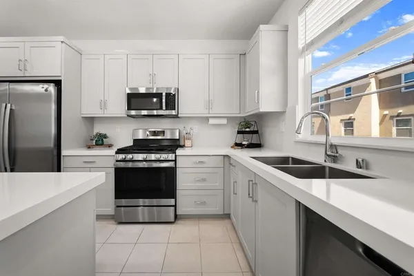 a kitchen with cabinets stainless steel appliances a sink and a counter space