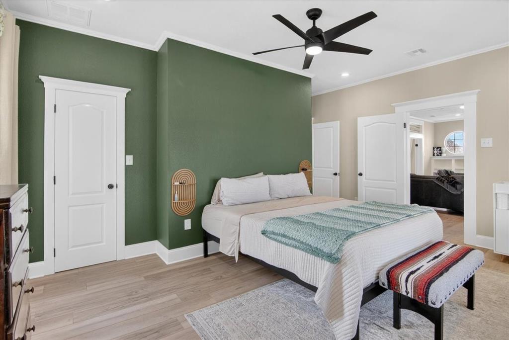 278 Leuschner Road Elm Mott, TX 76640 - Photo 21 of 31 a bedroom with a bed and a chandelier