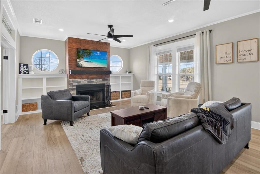 278 Leuschner Road Elm Mott, TX 76640 - Photo 7 of 31 a living room with furniture a flat screen tv and a fireplace