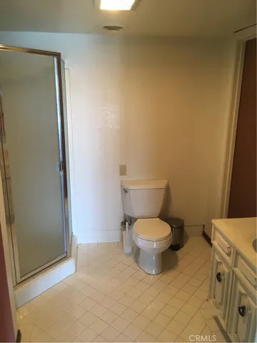 a white toilet sitting next to a bathroom sink
