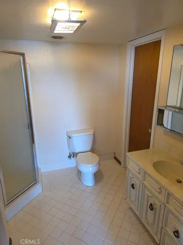a bathroom with a toilet sink and a mirror