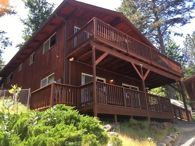 a view of backyard with deck and hardwood