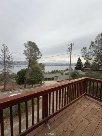 a view of a balcony with wooden floor and fence