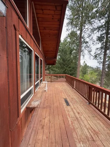 a view of balcony with wooden floor and fence