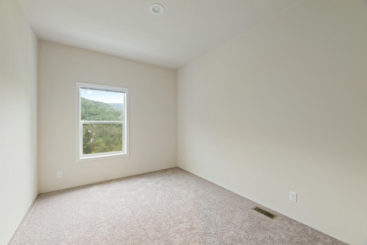 5572 Jumpoff Joe Creek Road Grants Pass, OR 97526 - Photo 18 of 38 an empty room with a window