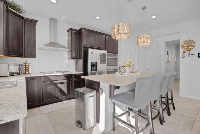 a kitchen with a table chairs refrigerator and microwave