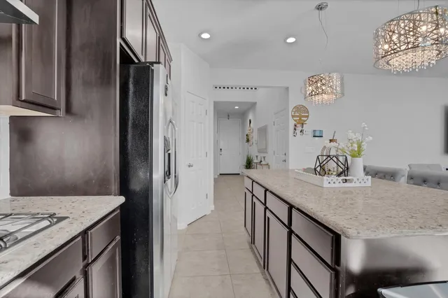 a kitchen with granite countertop cabinets a sink and appliances
