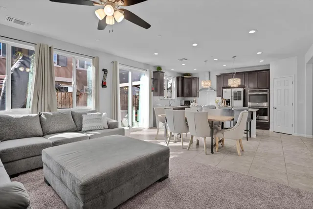 a living room with furniture and kitchen view