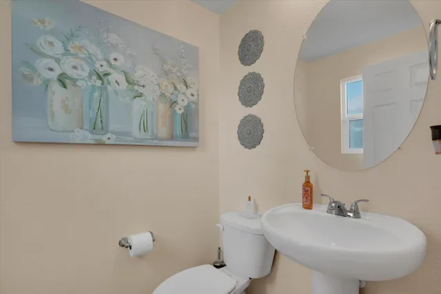 a bathroom with a sink mirror and toilet