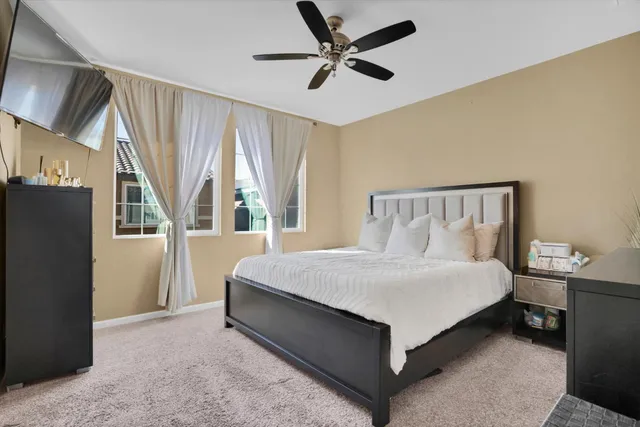 a bedroom with a bed and a large window