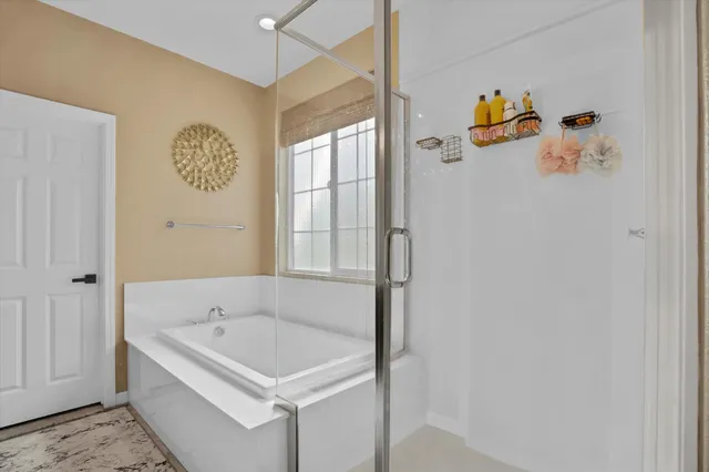a bathroom with a tub and shower