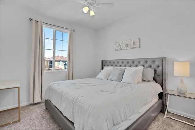 a bedroom with a large bed and a window