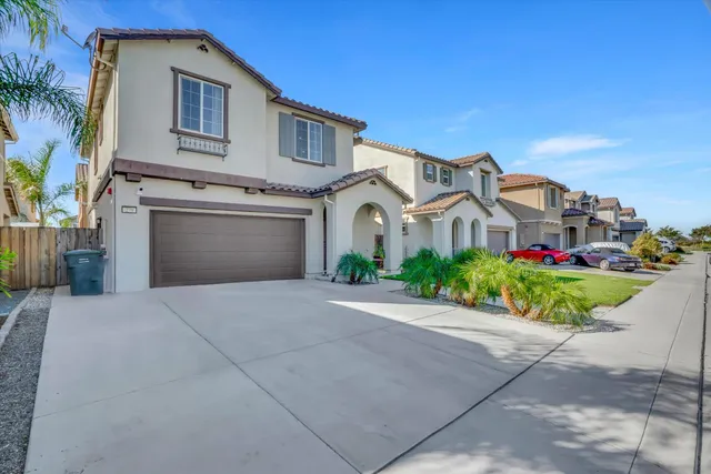 a front view of a house with a yard and a garage