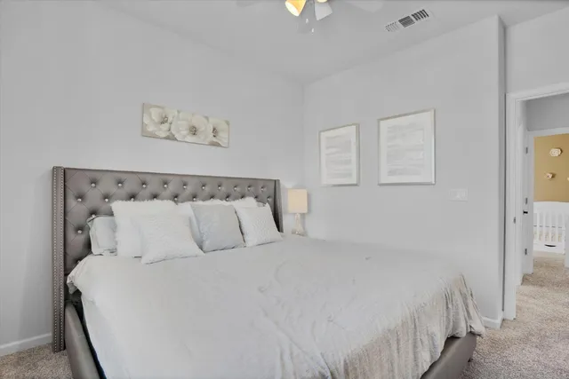 a bedroom with a bed and a painting on the wall