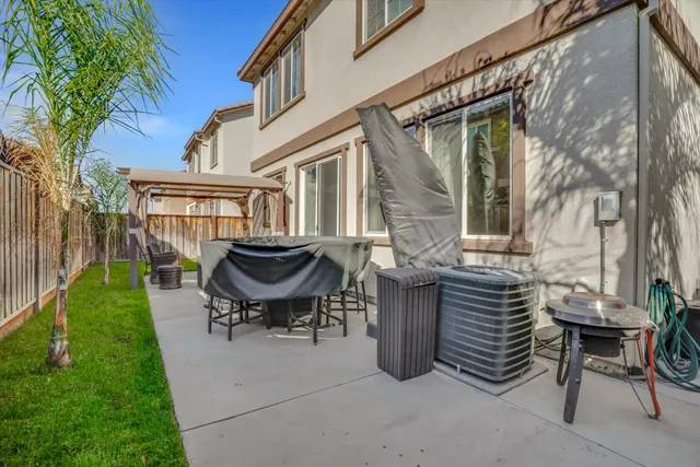 a view of a patio with table and chairs and potted plants