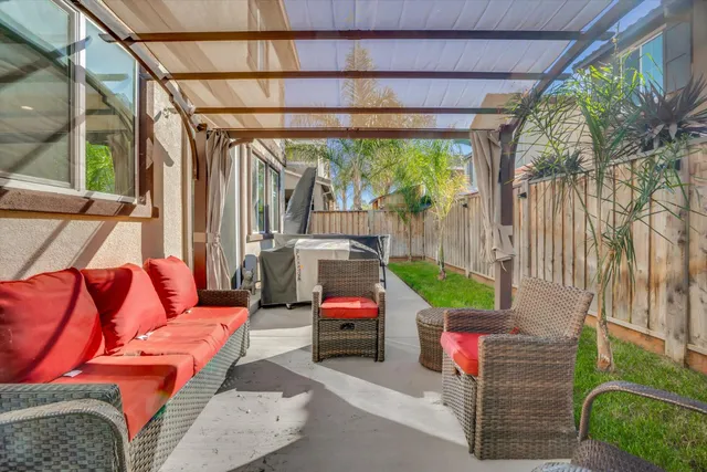 a backyard of a house with outdoor seating and green space