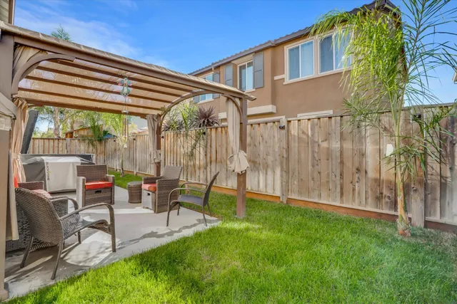a view of backyard with a table and chairs
