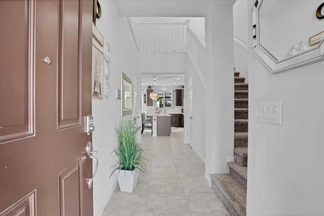 a view of a hallway with wooden floor and a living room