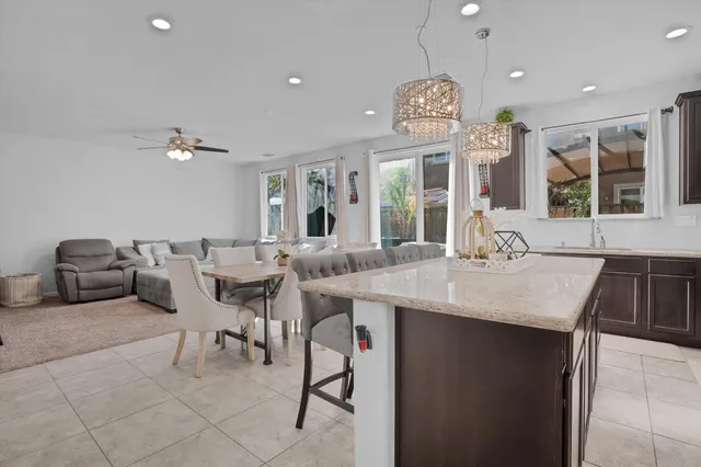 a view of a dining room with furniture a chandelier and wooden floor