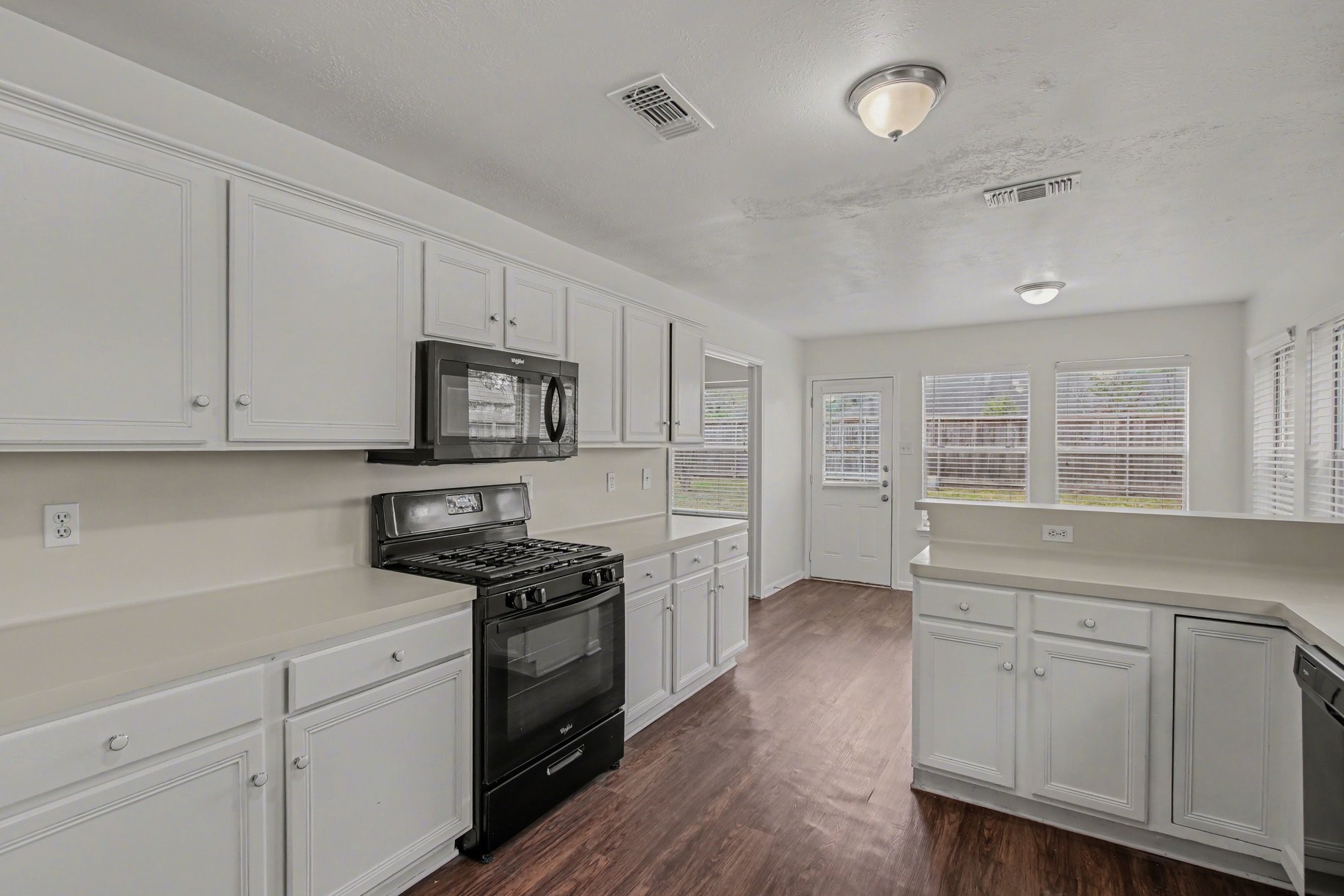 7203 Glen Rosa Drive Katy, TX 77494 - Photo 11 of 28 a kitchen with granite countertop white cabinets and stainless steel appliances