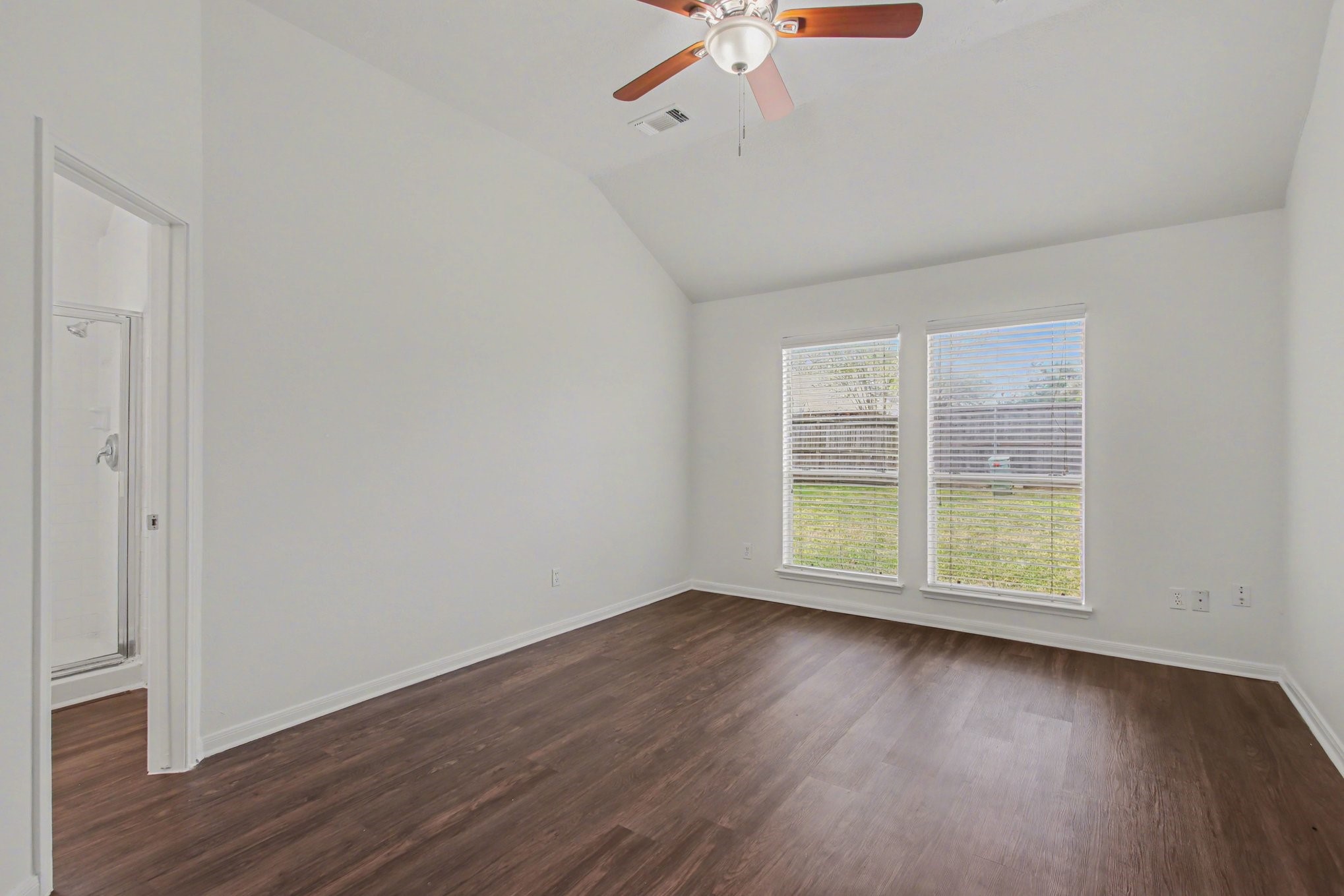 7203 Glen Rosa Drive Katy, TX 77494 - Photo 13 of 28 an empty room with wooden floor and windows