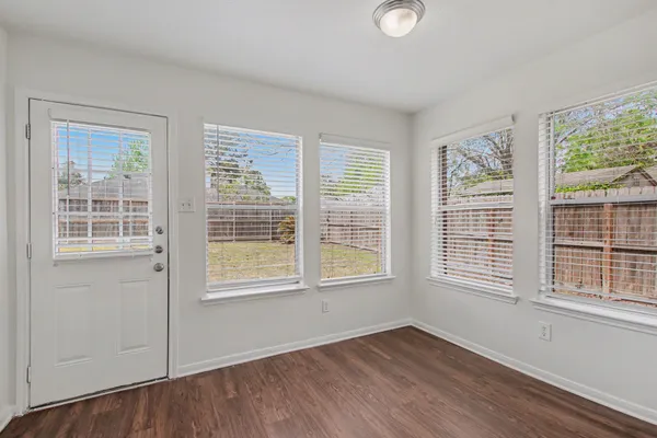 a view of entryway and hall with wooden floor