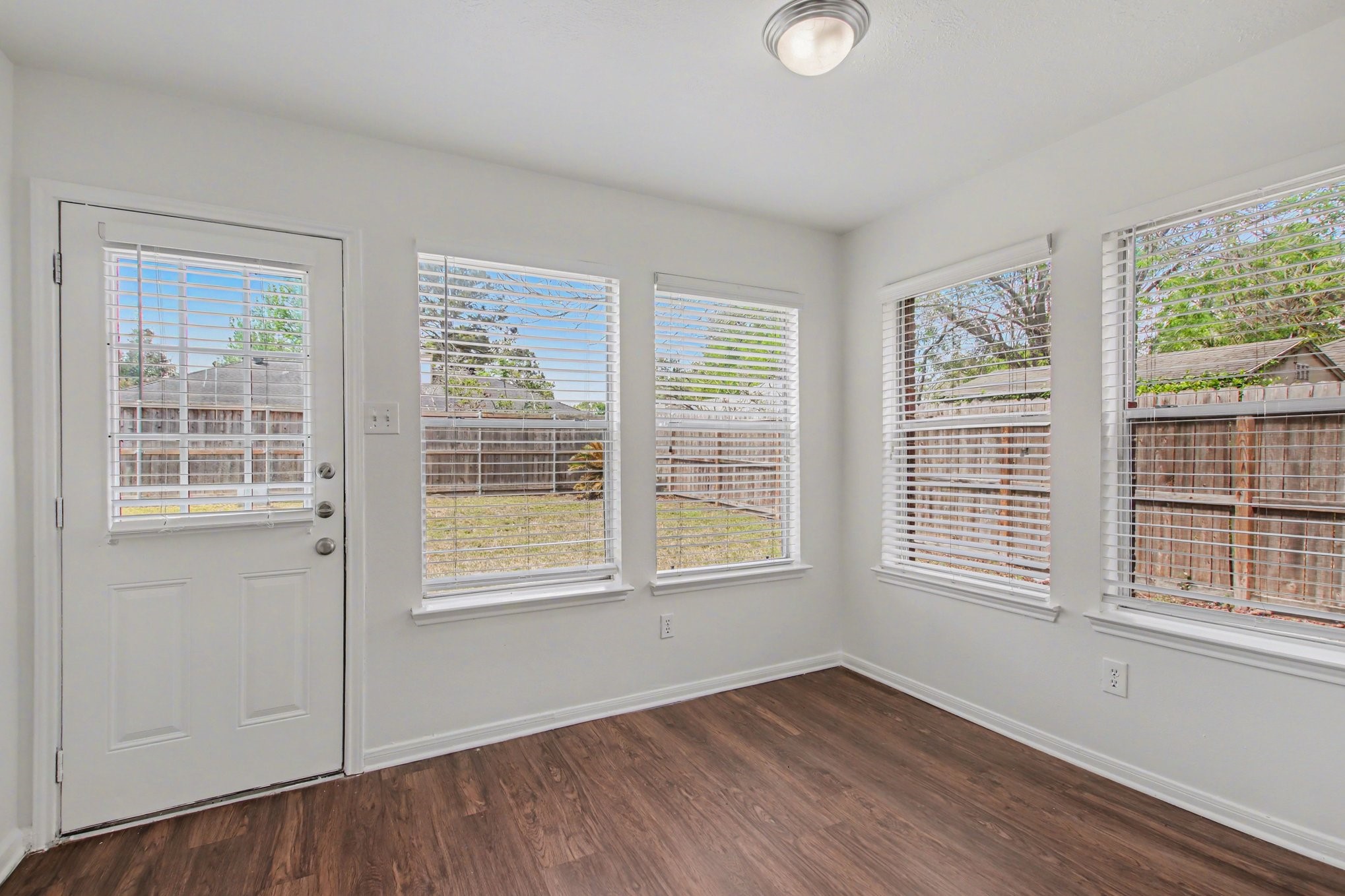 7203 Glen Rosa Drive Katy, TX 77494 - Photo 24 of 28 a view of an empty room with wooden floor and windows