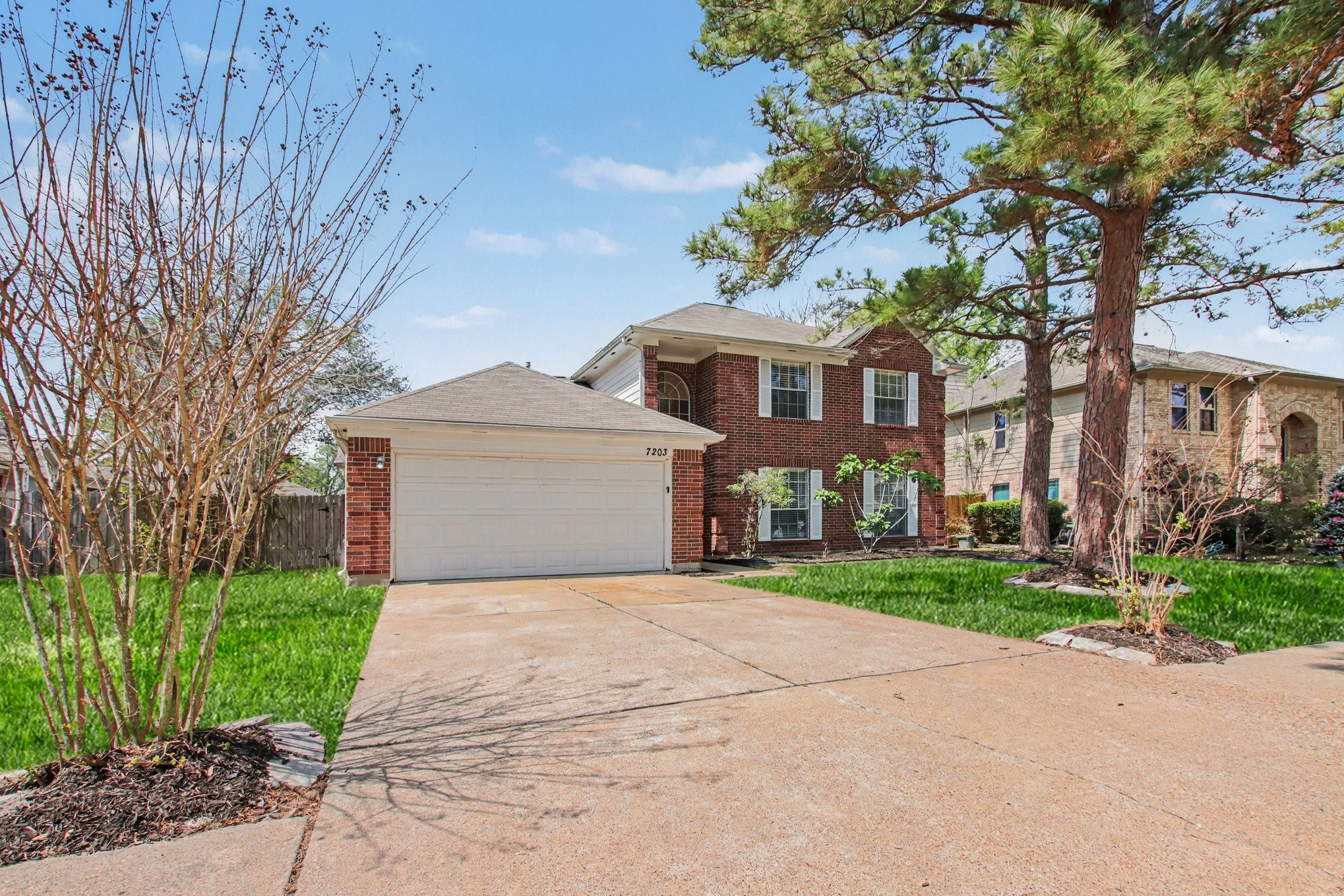7203 Glen Rosa Drive Katy, TX 77494 - Photo 3 of 28 a front view of a house with a garden and trees