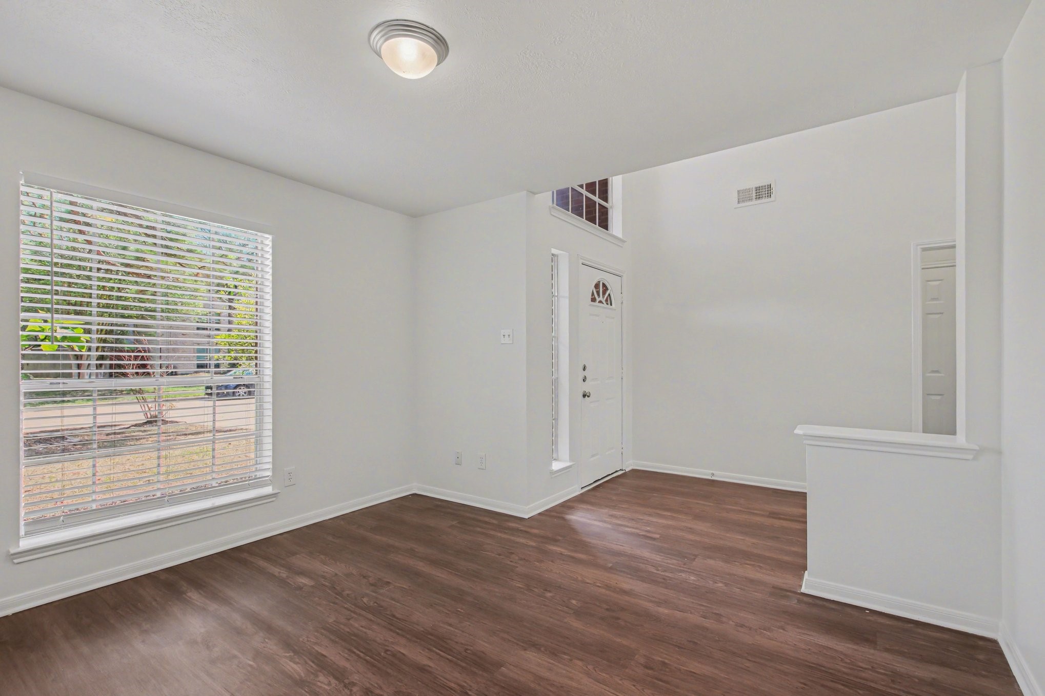 7203 Glen Rosa Drive Katy, TX 77494 - Photo 6 of 28 a view of an empty room with wooden floor and a window