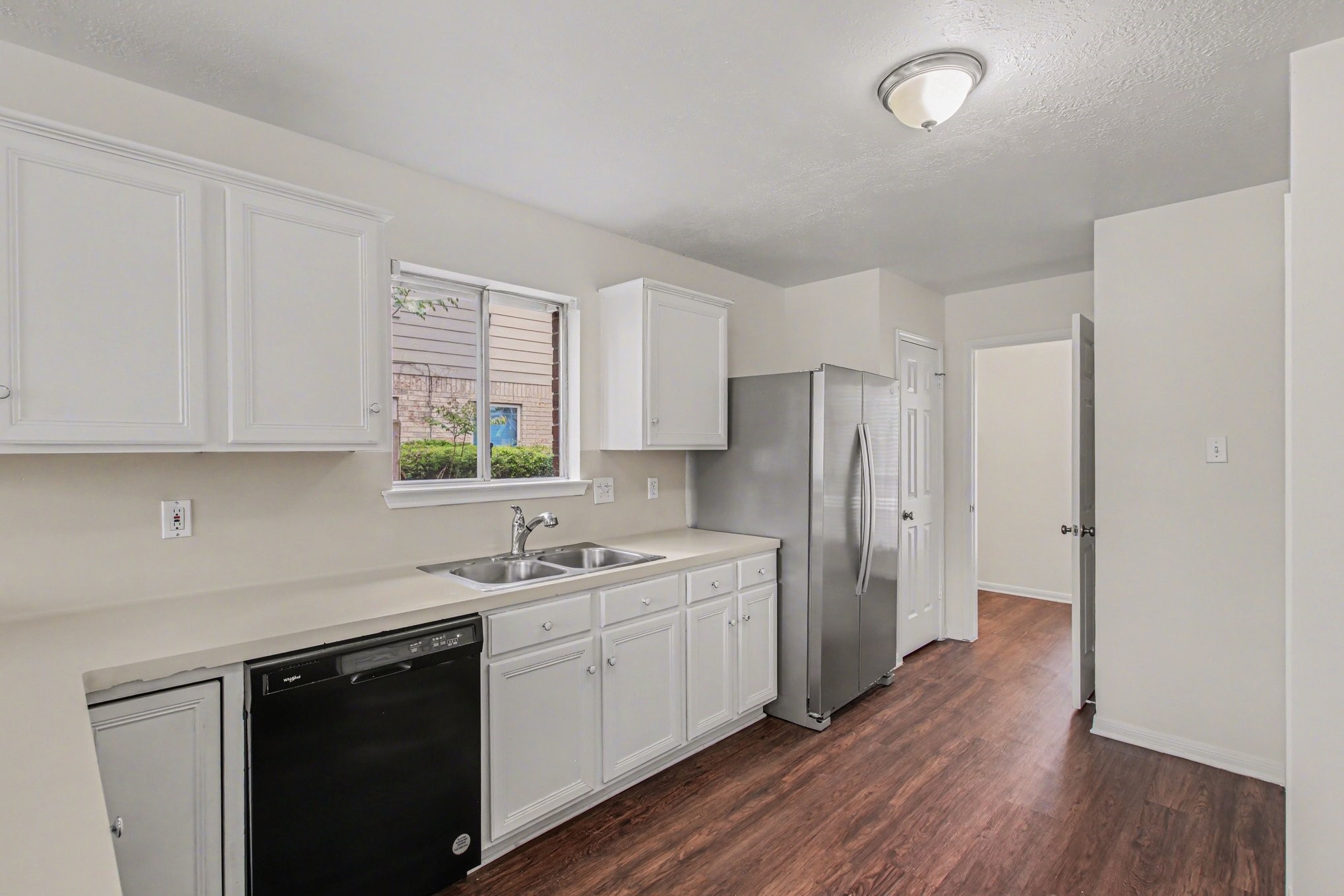 7203 Glen Rosa Drive Katy, TX 77494 - Photo 10 of 28 a kitchen with a sink cabinets stainless steel appliances and a window