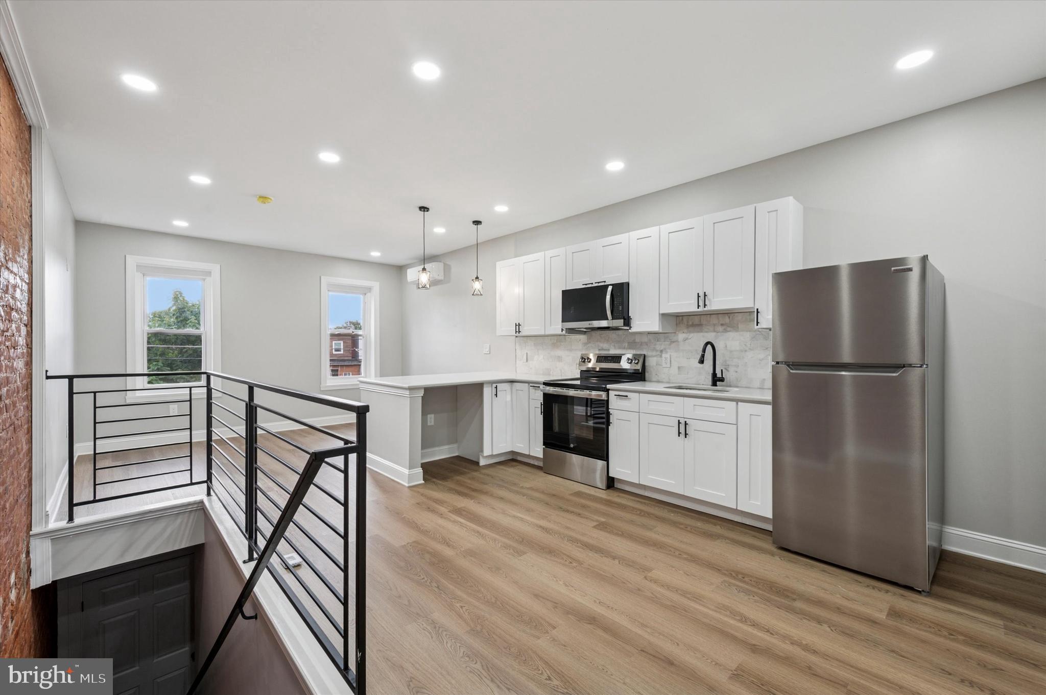 2917 North 7th Street, Unit 2 Philadelphia, PA 19133 - Photo 3 of 7 a kitchen with stainless steel appliances a refrigerator a stove top oven and kitchen island
