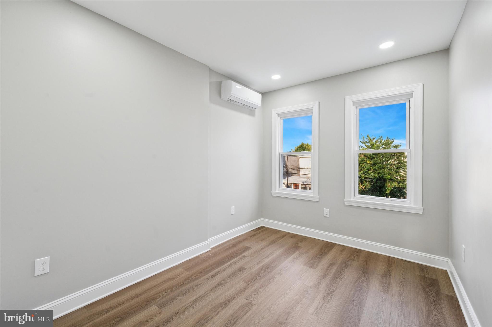 2917 North 7th Street, Unit 2 Philadelphia, PA 19133 - Photo 6 of 7 an empty room with wooden floor and windows