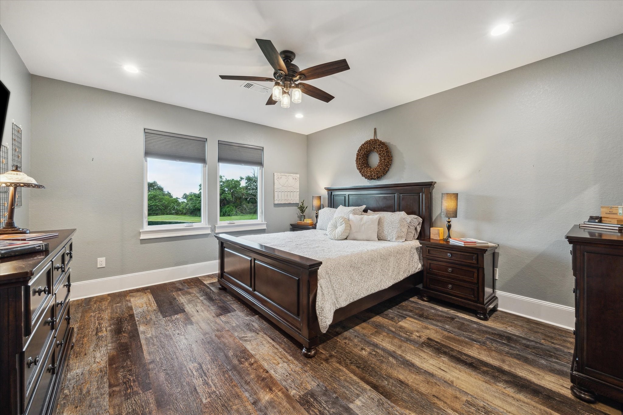 1255 Bronco Trail Angleton, TX 77515 - Photo 27 of 50 This serene upstairs bedroom offers stunning views of the back pond, creating a peaceful retreat. It includes a private bathroom for ultimate convenience and privacy, along with a laundry room chute for easy access to the laundry room below. The spacious walk-in closet provides plenty of storage, while the oversized shower with a sleek sliding glass door adds a touch of luxury. A perfect blend of comfort and practicality!