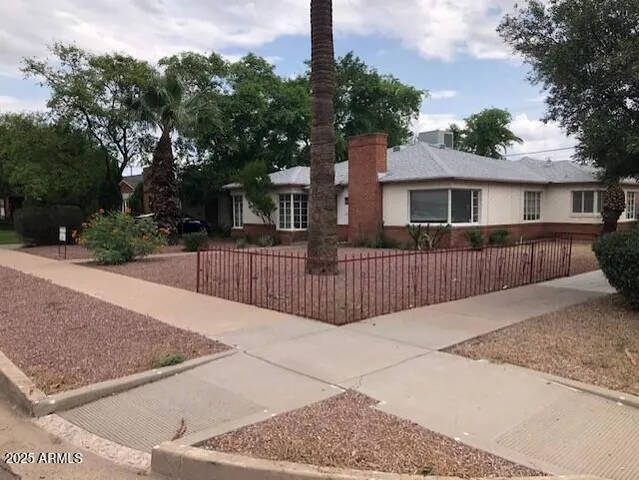 a view of a house with a wooden fence