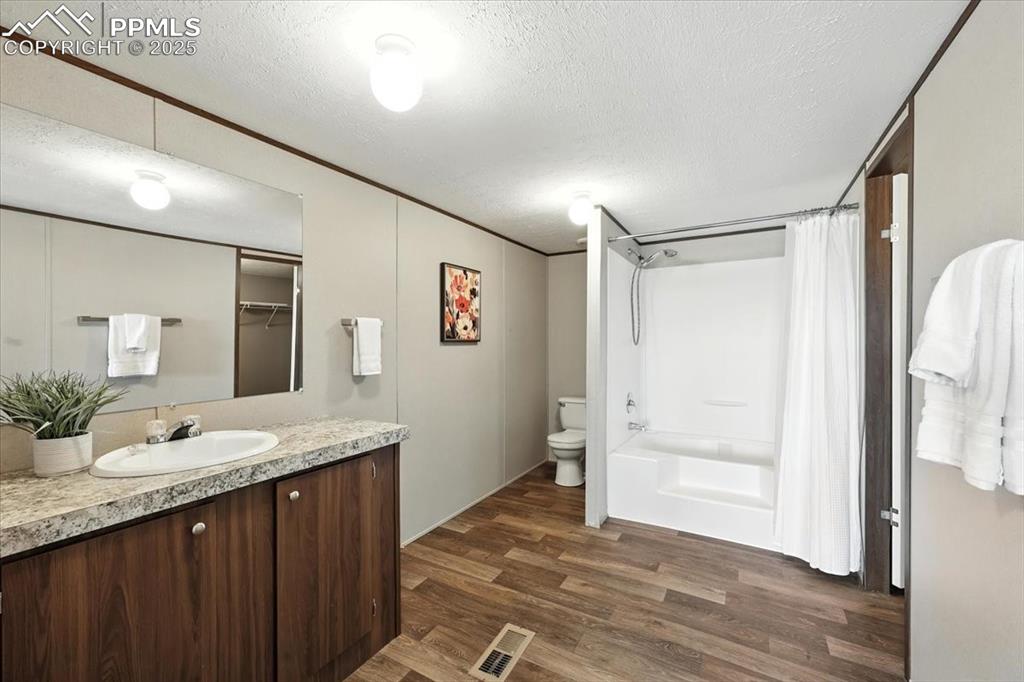 13560 Whittemore Road Yoder, CO 80864 - Photo 19 of 50 a bathroom with a granite countertop sink and a mirror