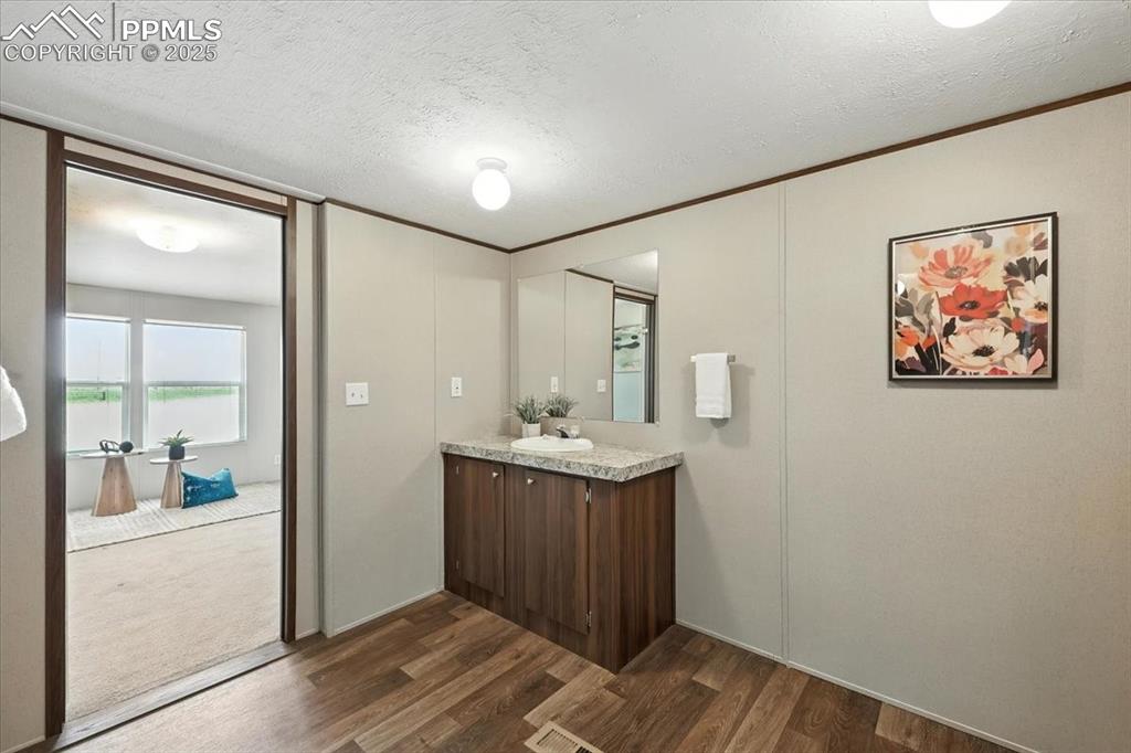 13560 Whittemore Road Yoder, CO 80864 - Photo 20 of 50 a bathroom with a sink and mirror with shower