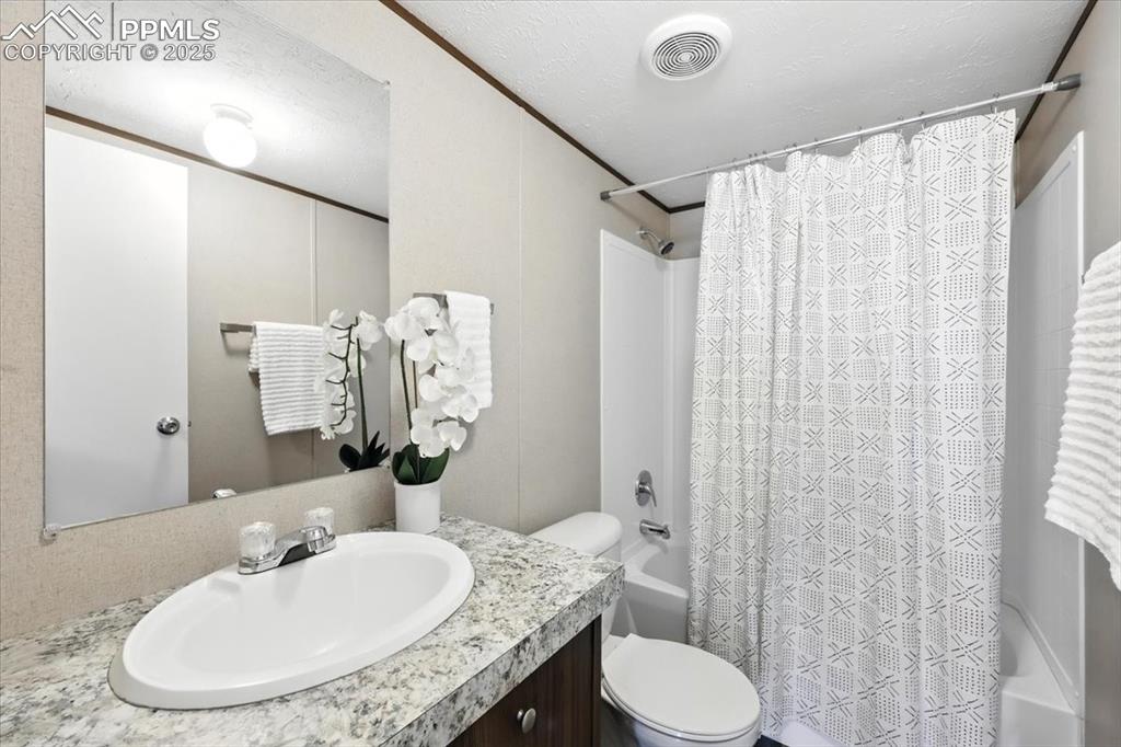 13560 Whittemore Road Yoder, CO 80864 - Photo 26 of 50 a bathroom with a granite countertop sink toilet and a mirror